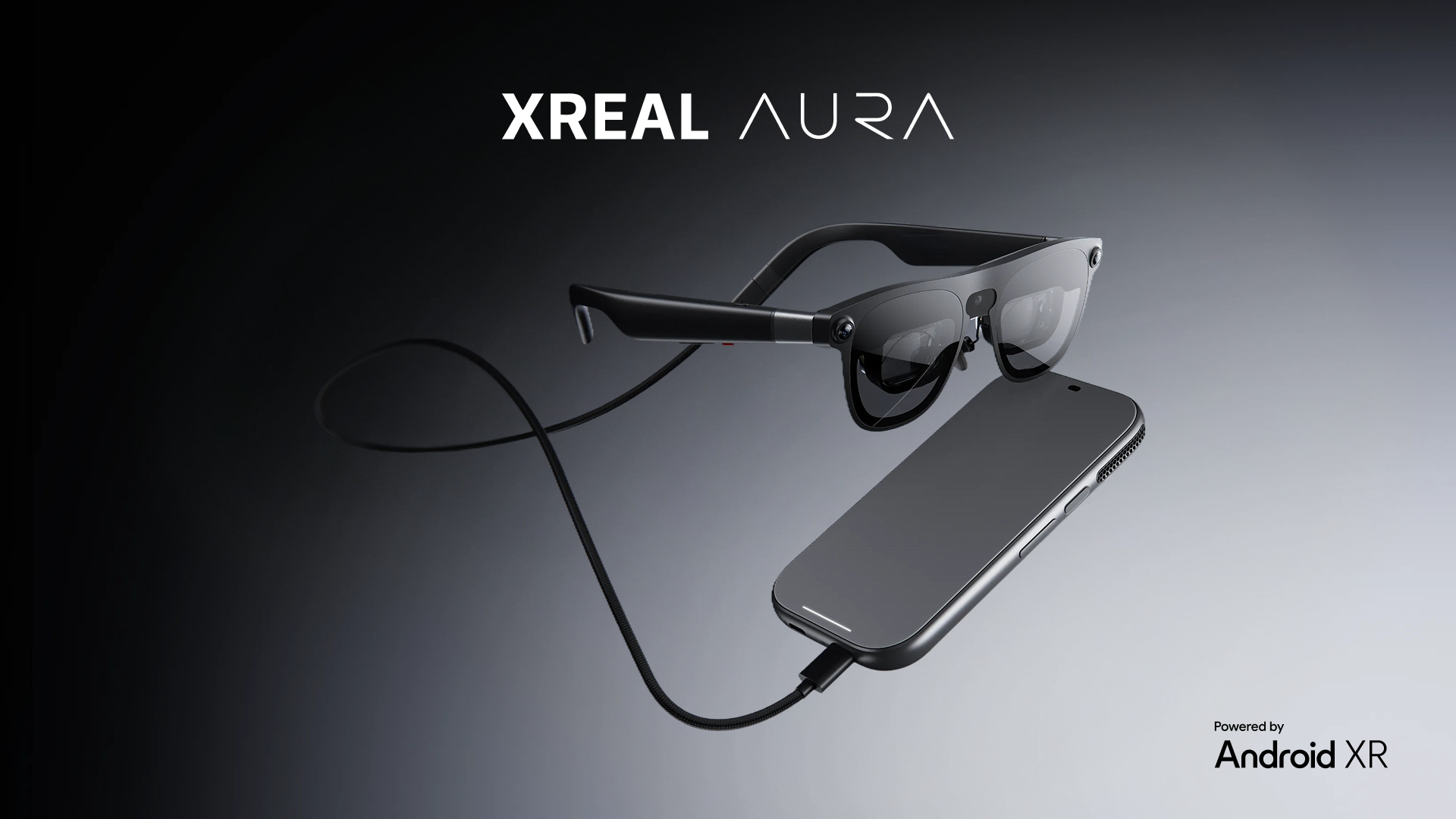 Official XREAL AURA product render showing the glasses connected by cable to a separate compute module.